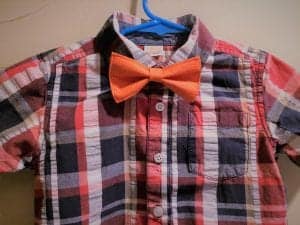 Close up of plaid blue and red shirt with handmade bowtie in orange.