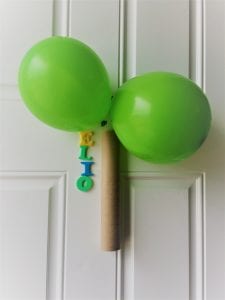 Green balloons taped over paper towel roll for palm tree.