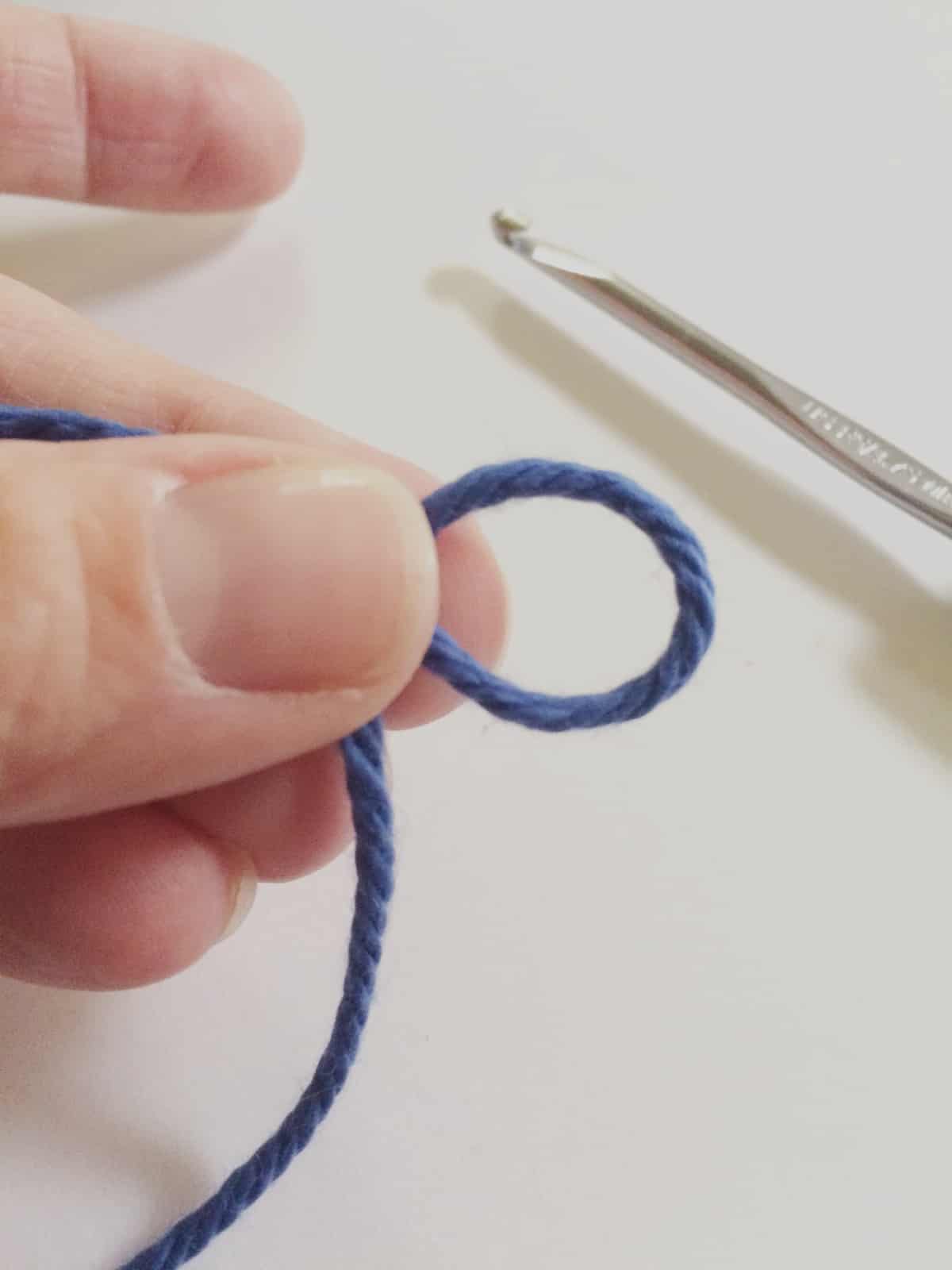 Pinch slip knot closed and slide off finger.
