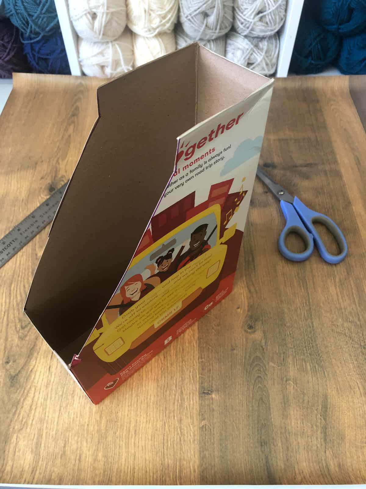 DIY cardboard notebook storage from a cereal box trimmed to size.