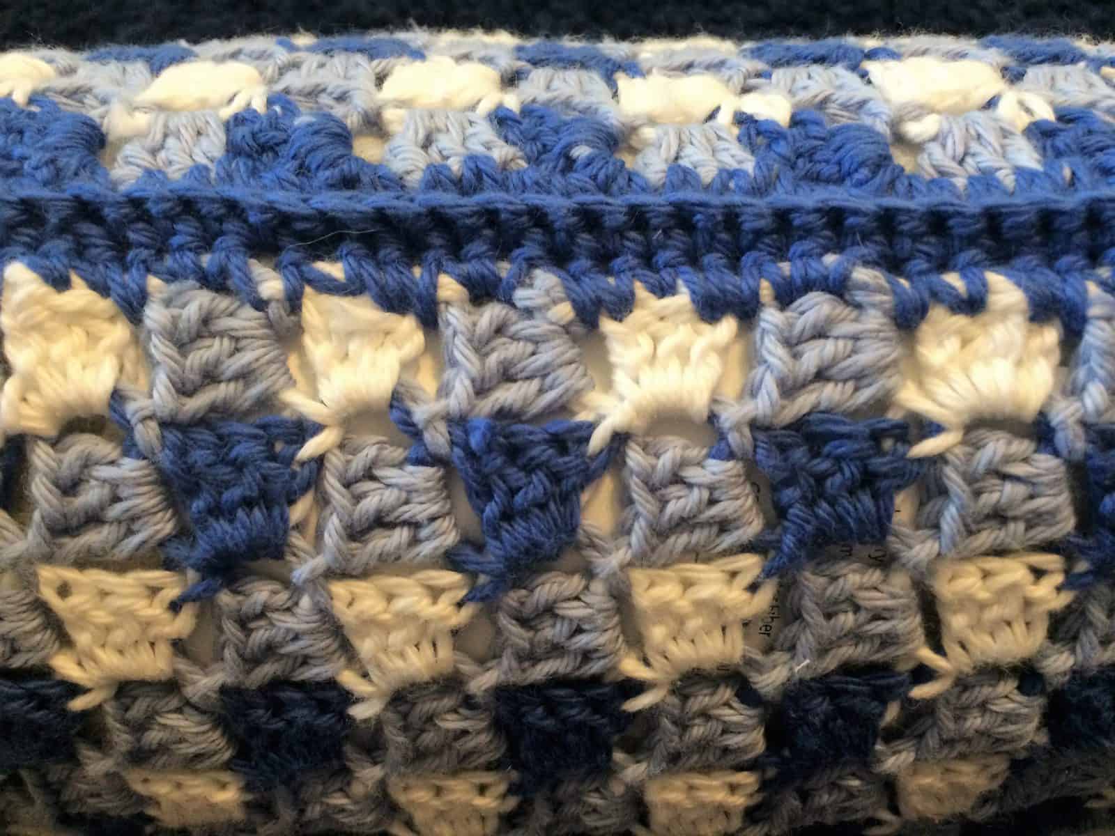 Finished edge on gingham crochet pillow.