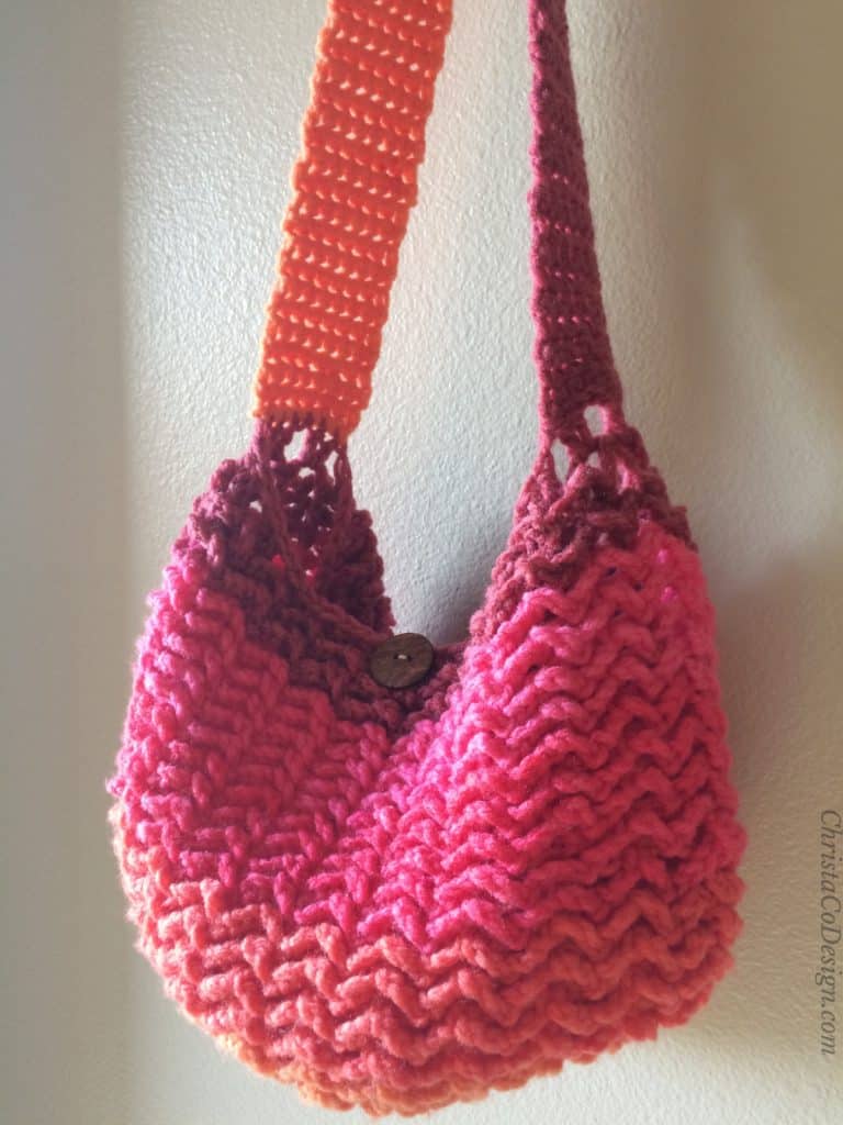 Pink and orange striped One Skein Crochet Market Bag Pattern hanging.