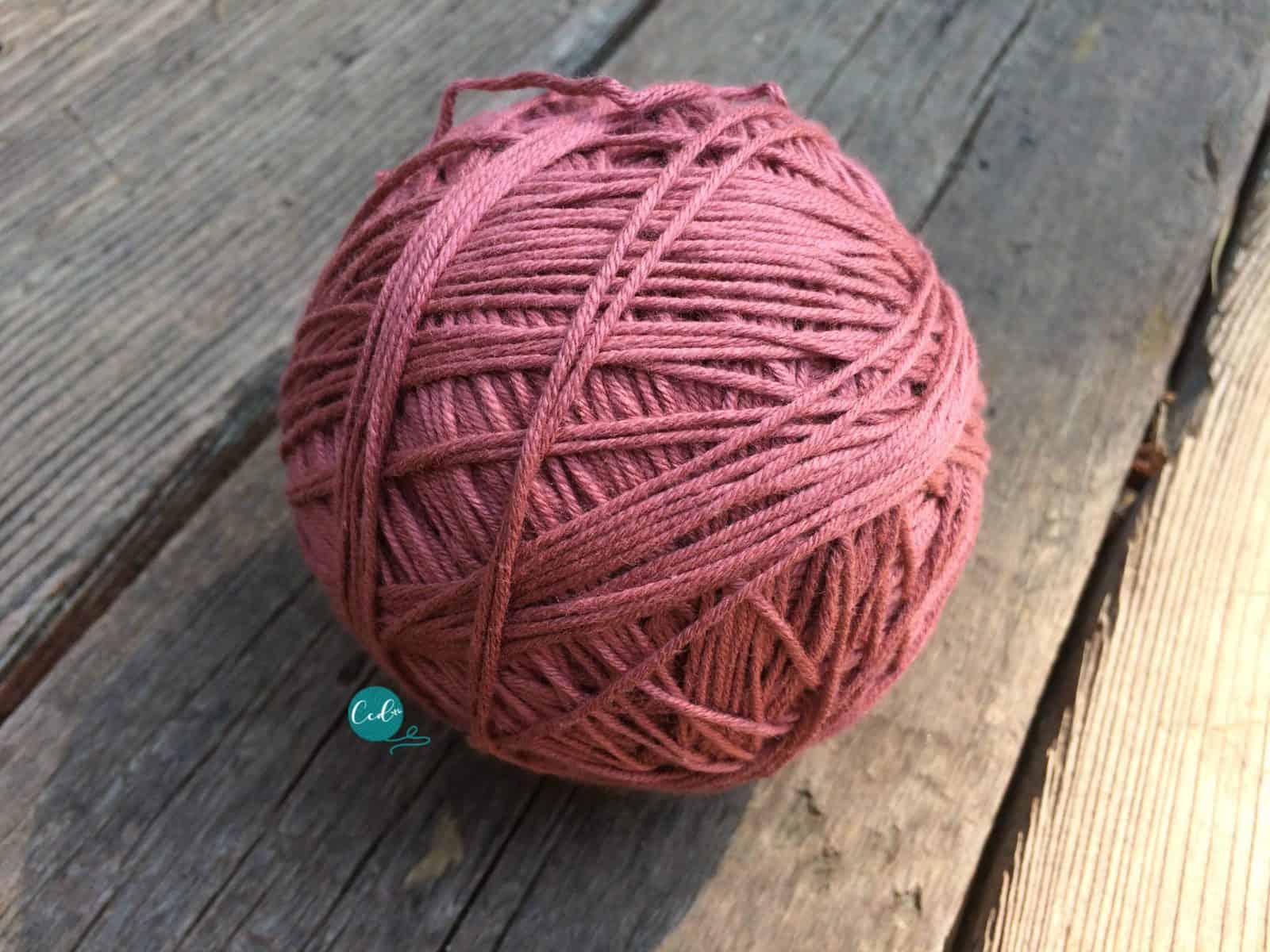 Large pink yarn ball wrapped from a hank.