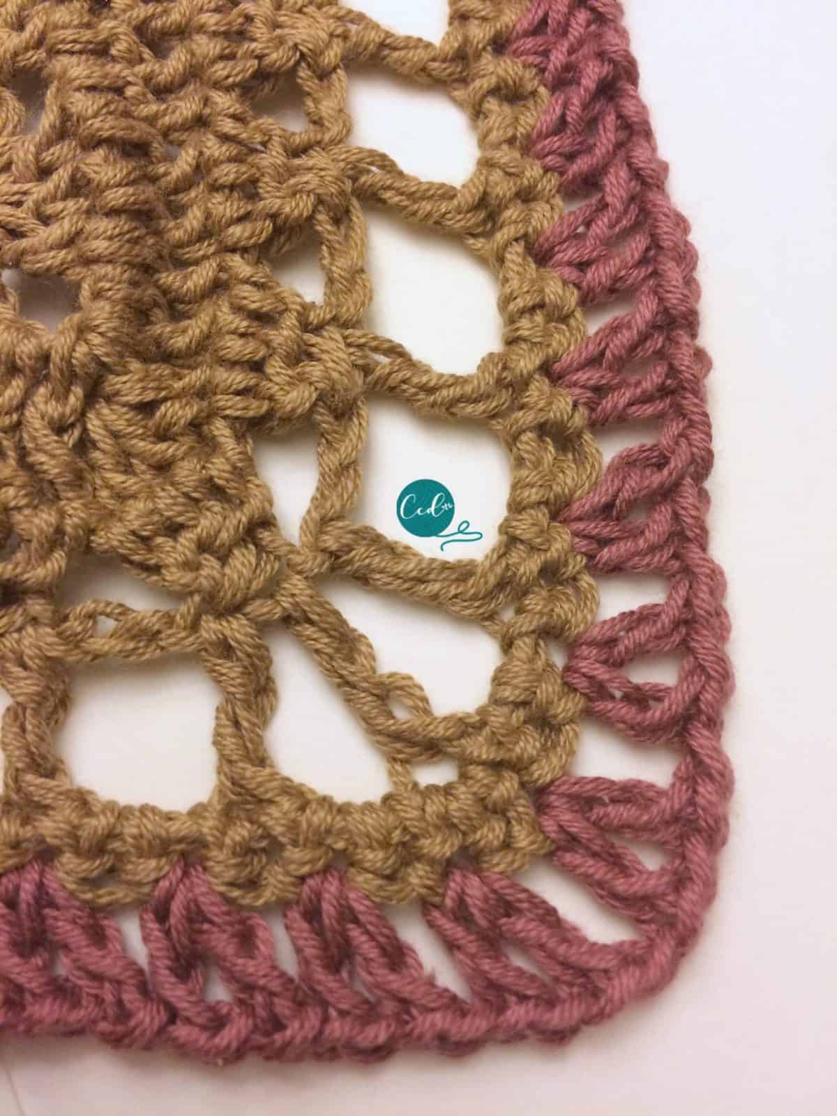 Pink stitches in crochet shawlette.