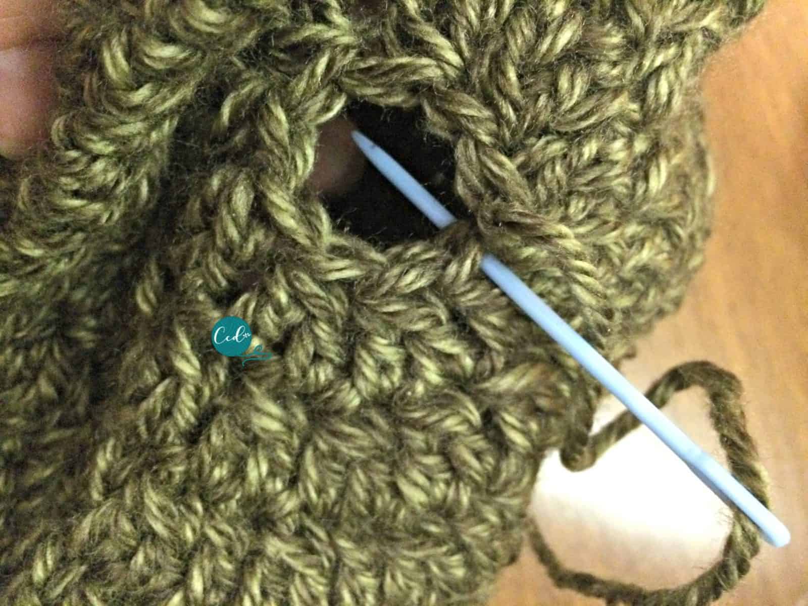 Insert yarn needle in stitches to close slouchy hat.