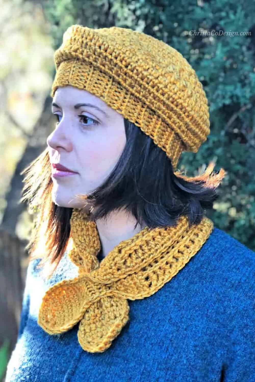 Woman in gold beret and scarflette.