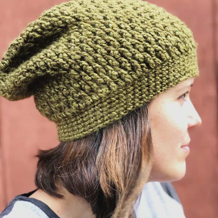 Woman looking to side with textured slouchy hat on.