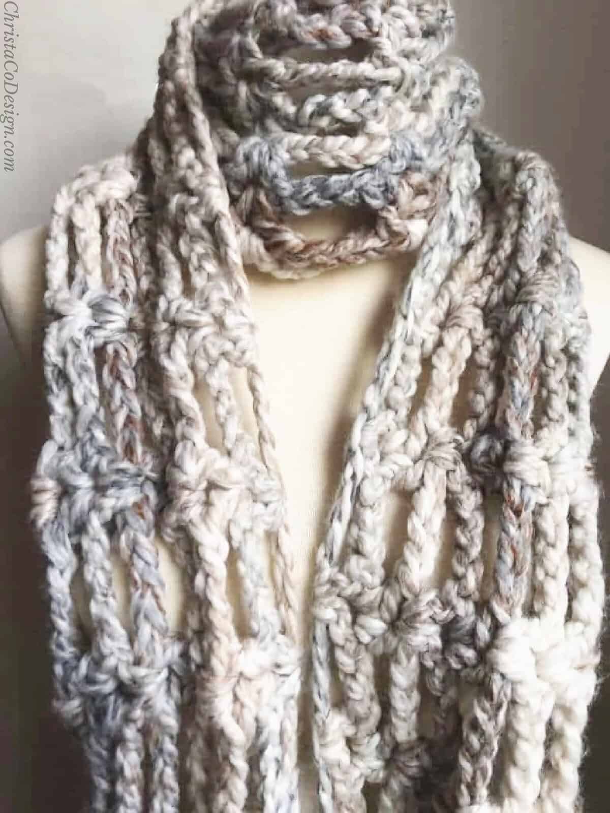 Super chunky crochet scarf on mannequin.