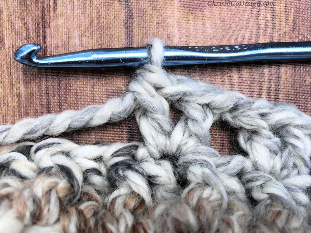 Close up of v-stitch and crochet hook.