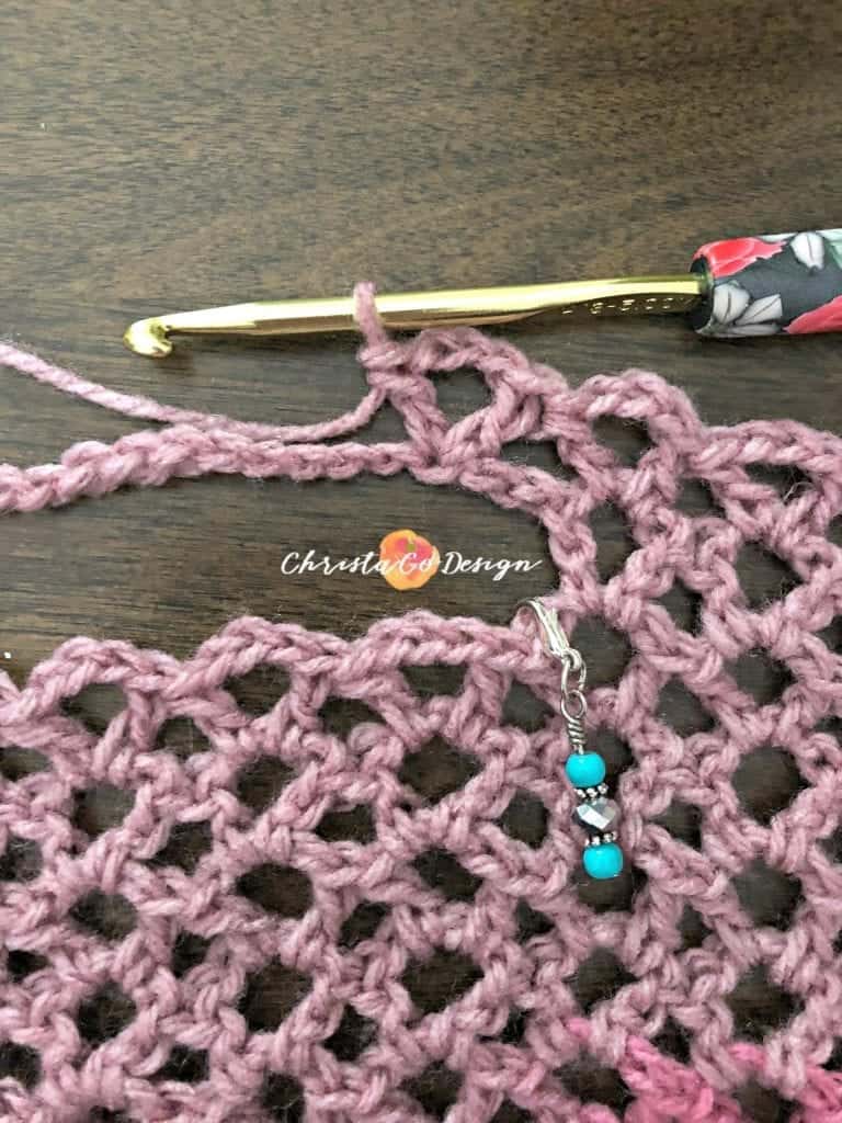 Continue to crochet stitches across neckline.