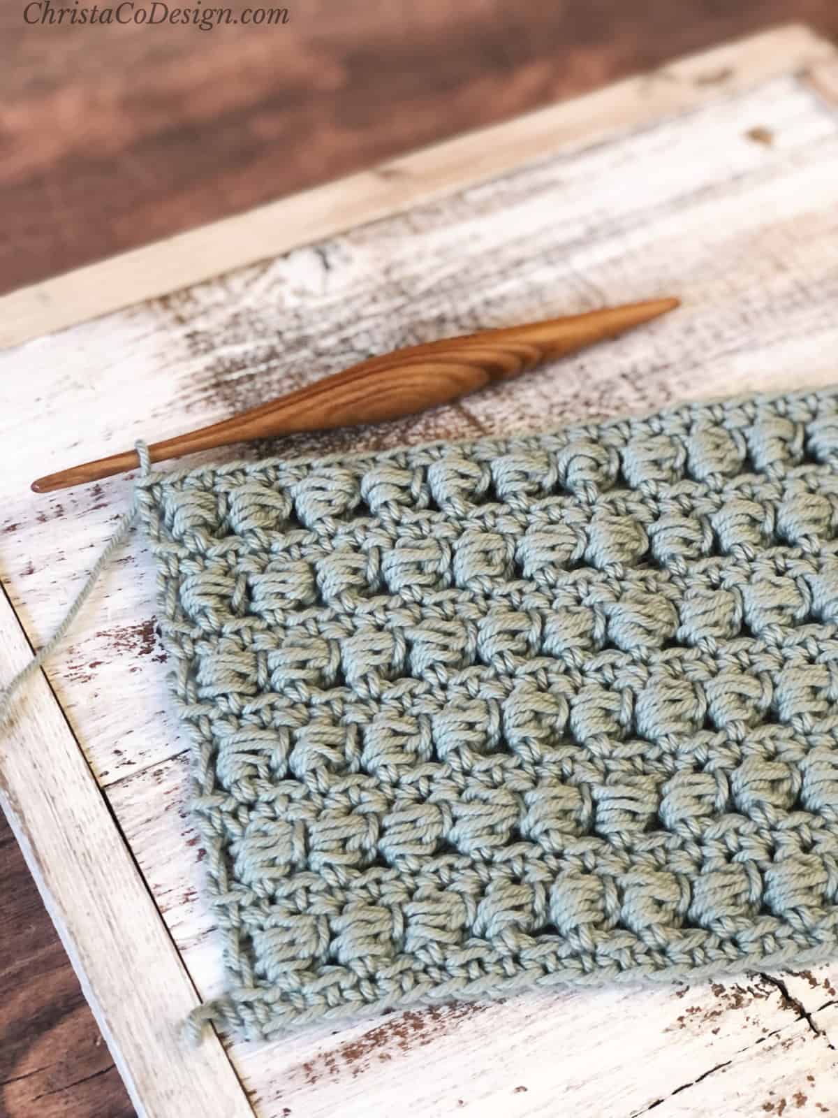 Crochet bead stitch in dishie yarn on hook.