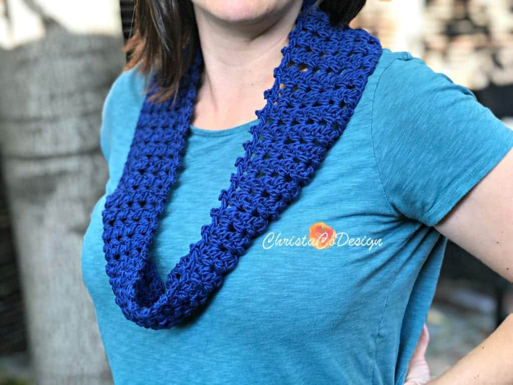 Woman in blue crochet cowl.