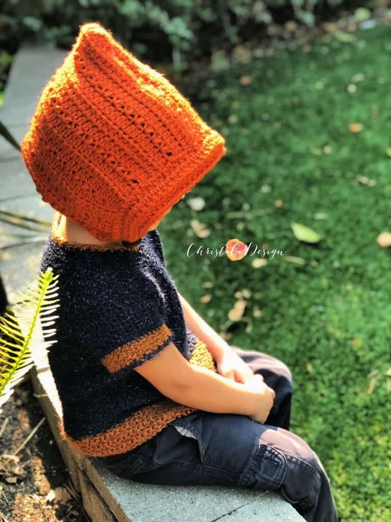 picture of boy in rust colored crochet pixie hat