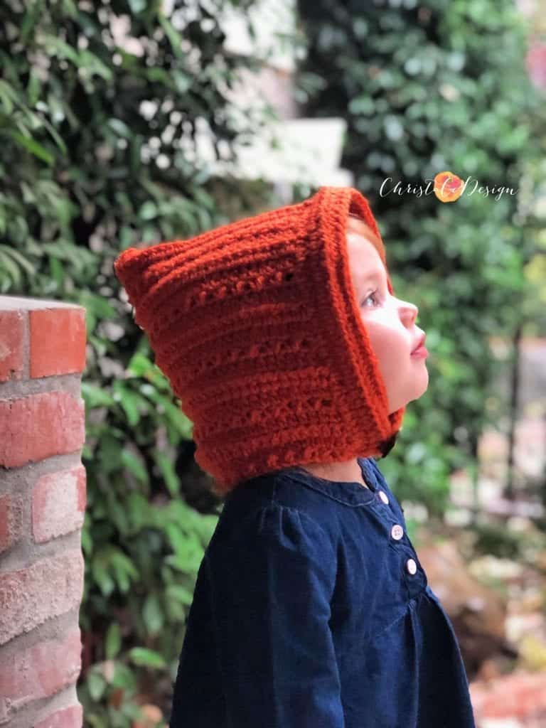 picture of toddler looking into rain with crochet pixie hat on