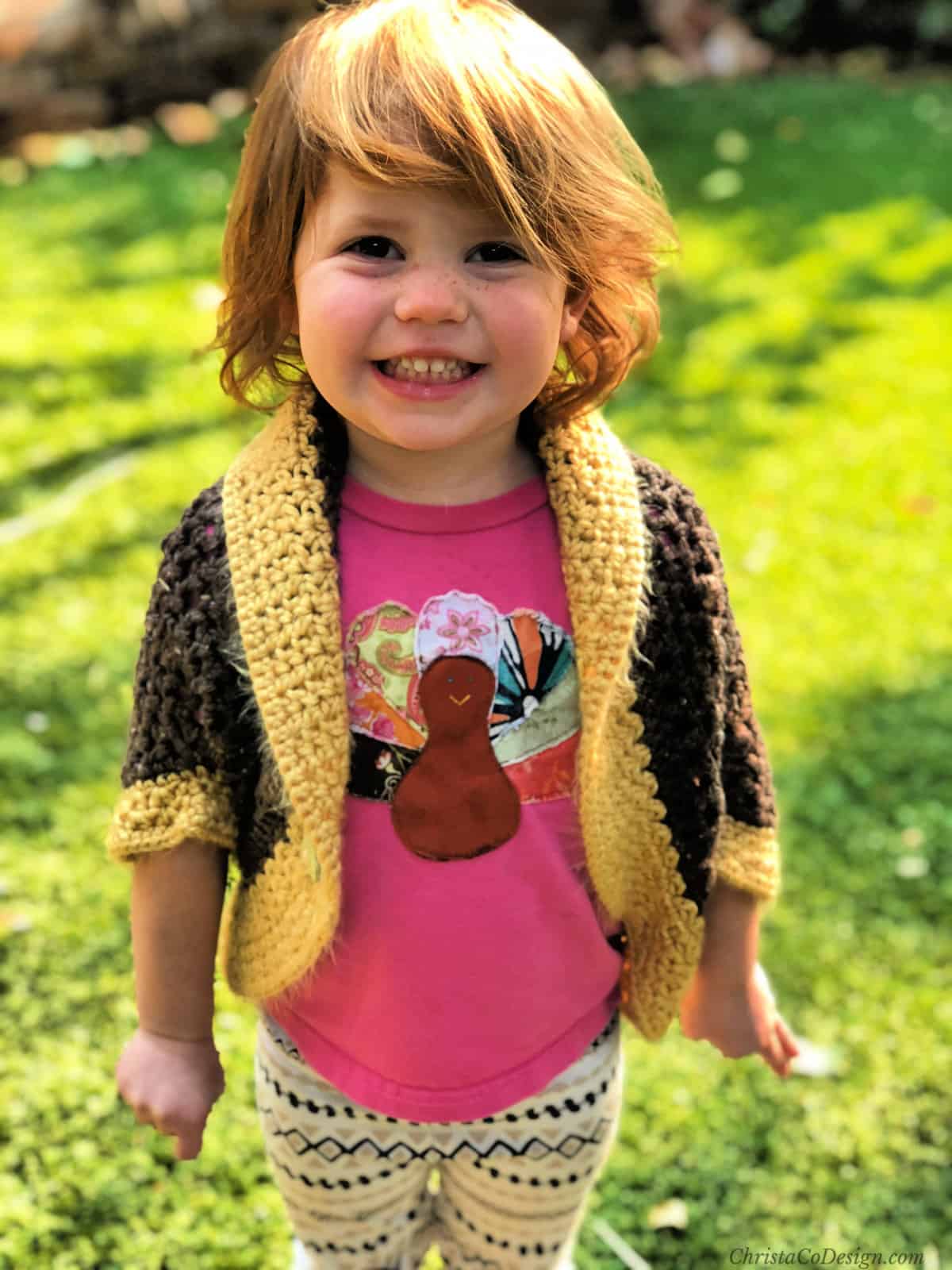 Girl with golden and brown shrug on smiling.