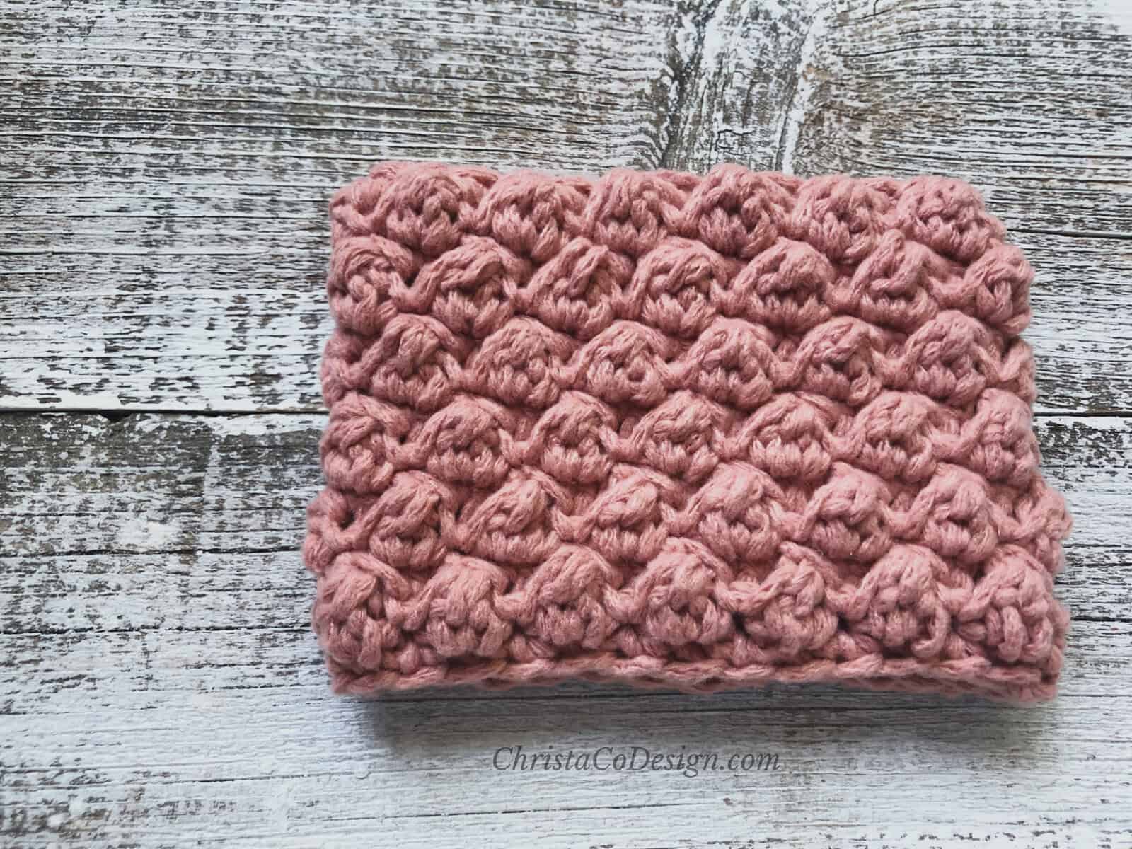 Pink crochet cup sleeve.