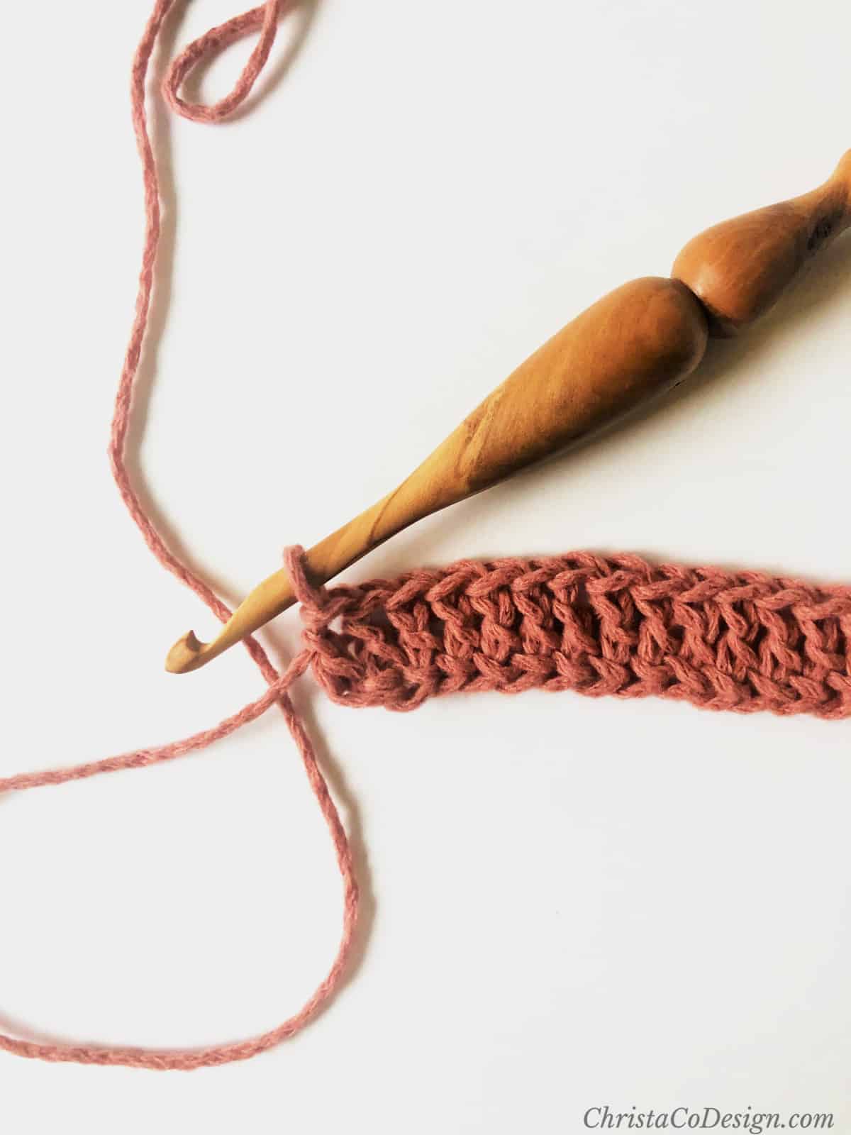 Last stitch of foundation double crochet row tutorial.