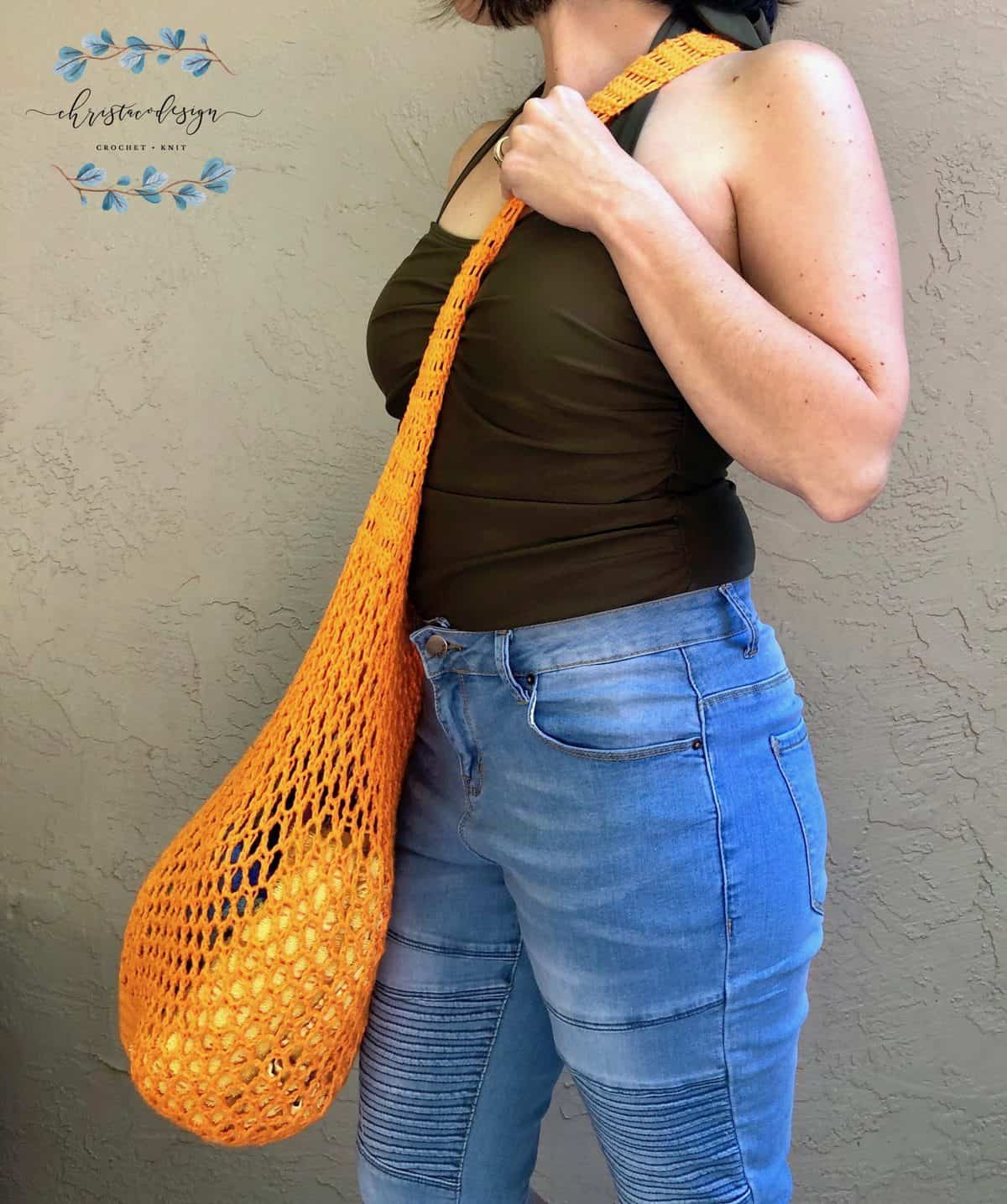picture of woman with crossbody strap of orange market tote bag 
