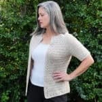Woman turned to side in short sleeve cardigan.