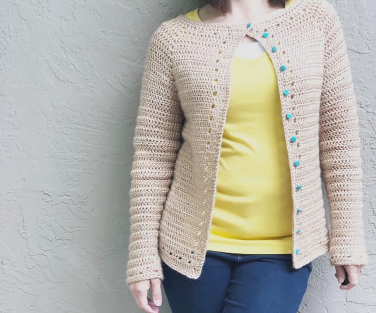 Woman in yellow wearing the Spring Crochet Cardigan.