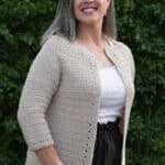 Woman in cardigan with 3/4 sleeves.