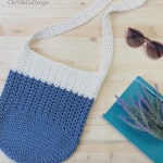 Square image of crochet bag with notebook and sunglasses.