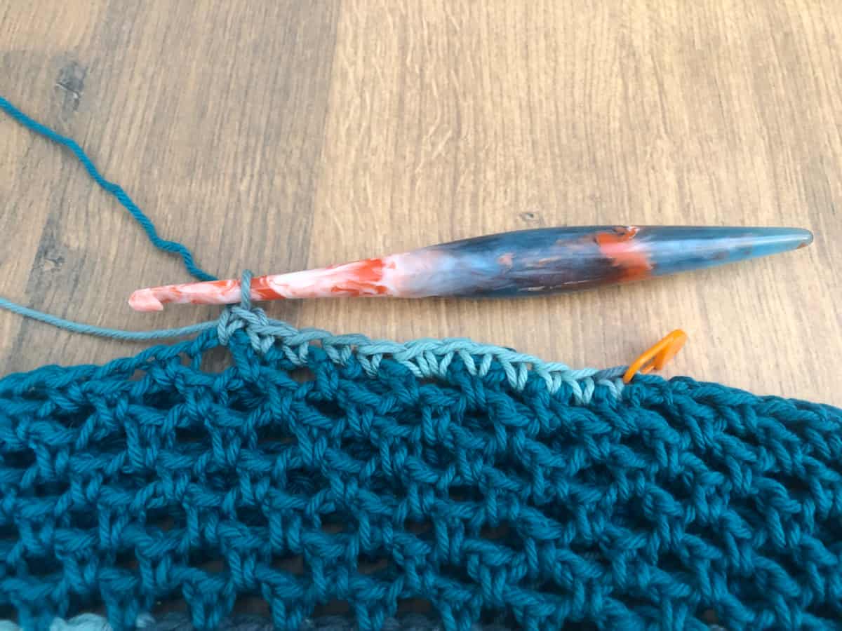 Row of variegated blue single crochet started.