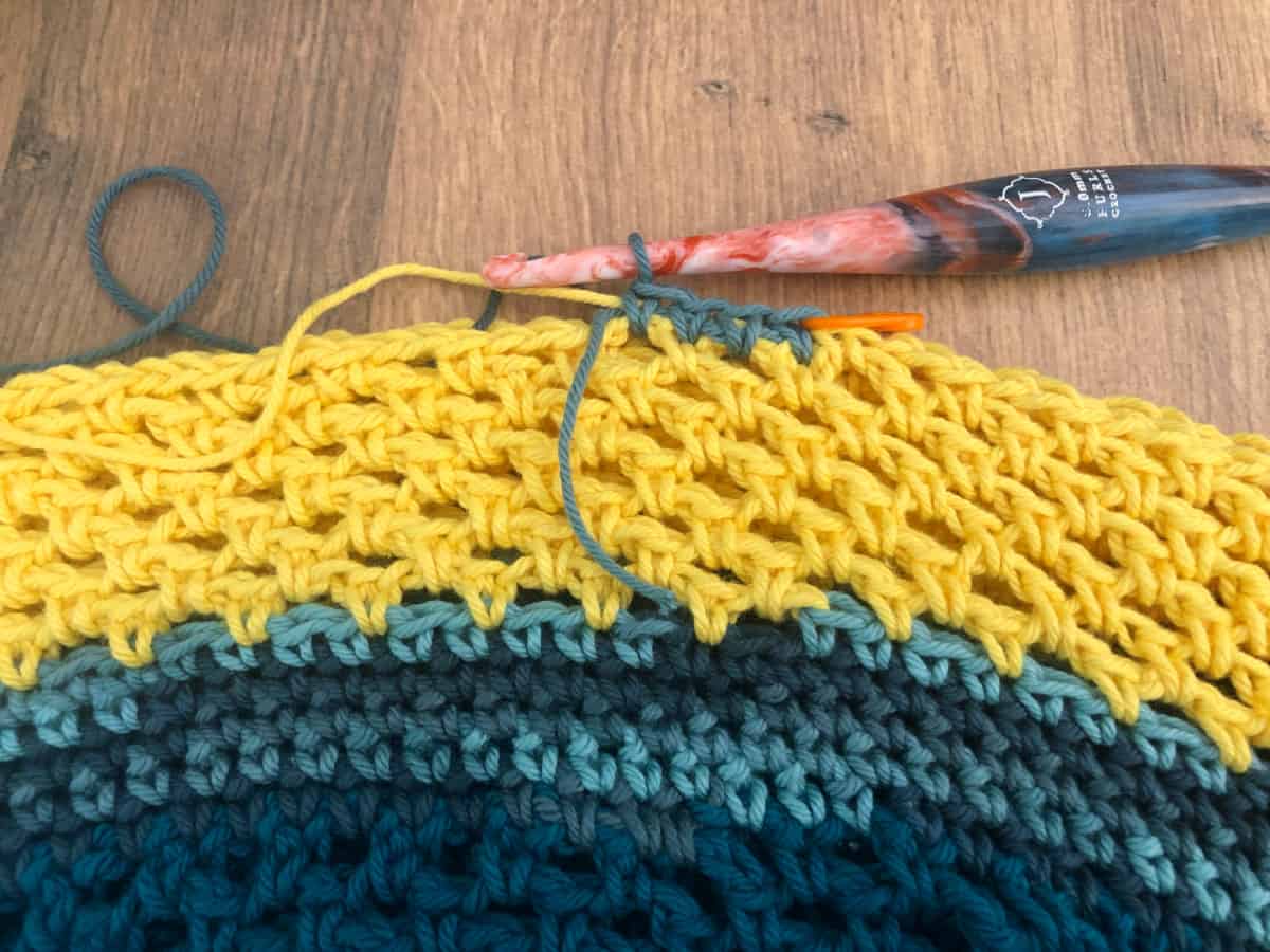 Blue row of single crochet started after 7 rows yellow.