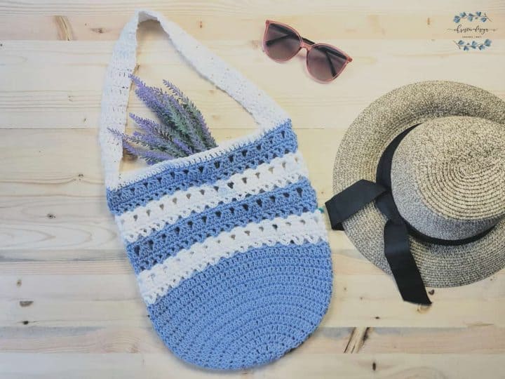Free crochet market tote pattern in striped blue and white flat lay.