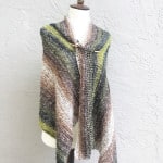 Full length view of striped crochet shawl on mannequin.