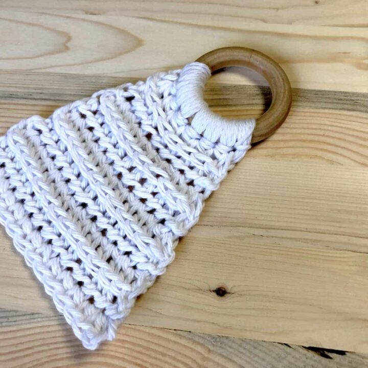 White crochet lovey on wood ring.
