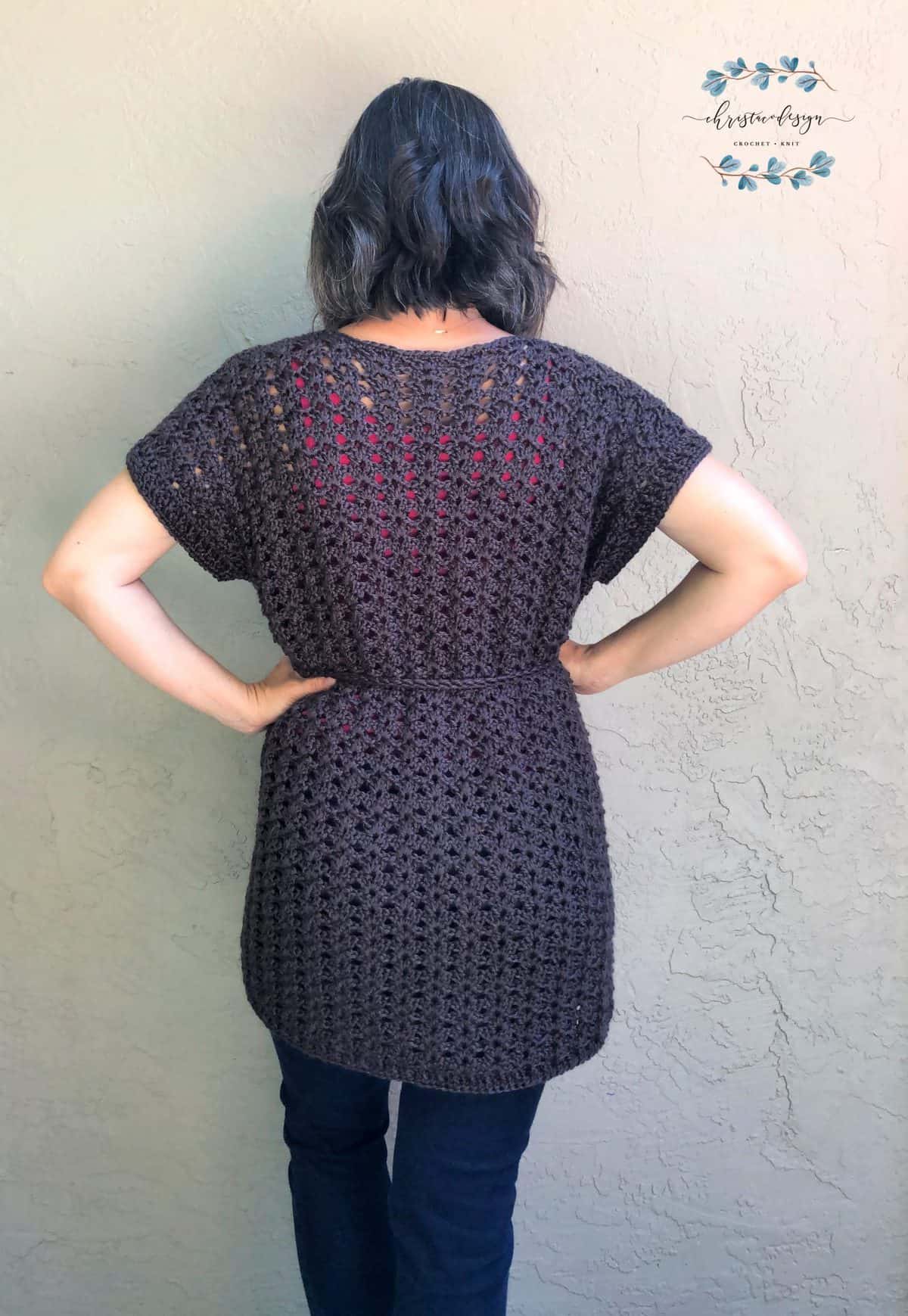 Back view of open stitch cardigan on woman.