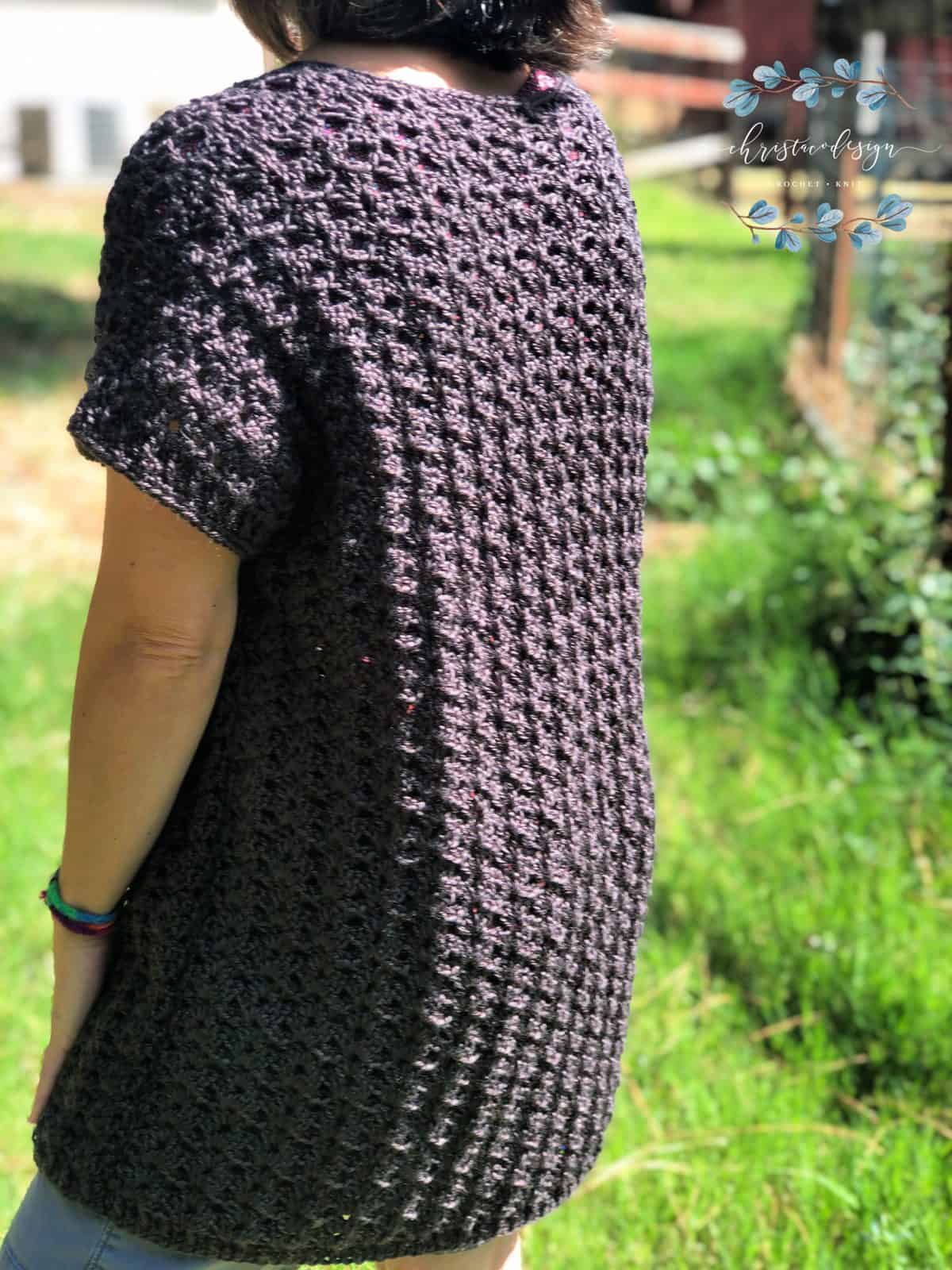 Sun shining off back of crochet cardigan pattern easy enough for black yarn outside.