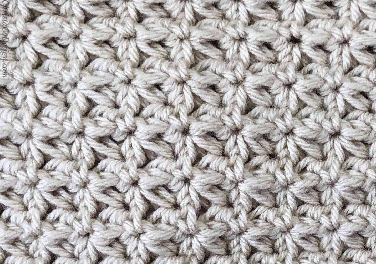 Close up of crochet swatch in trinity stitch in beige yarn.