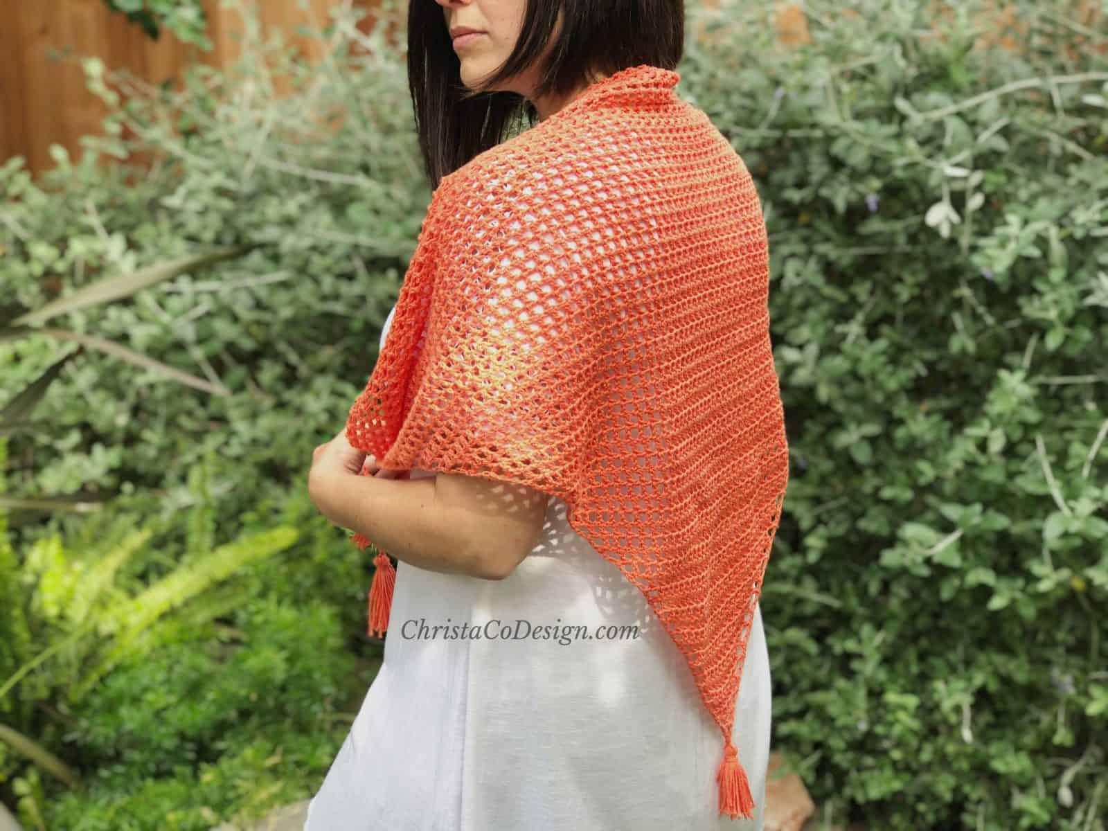picture of woman in coral triangle mesh crochet shawl 