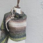 Beige green shawl wrapped mannequin.