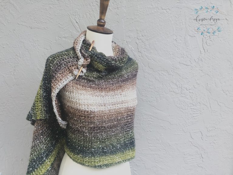 Beige green shawl wrapped mannequin.