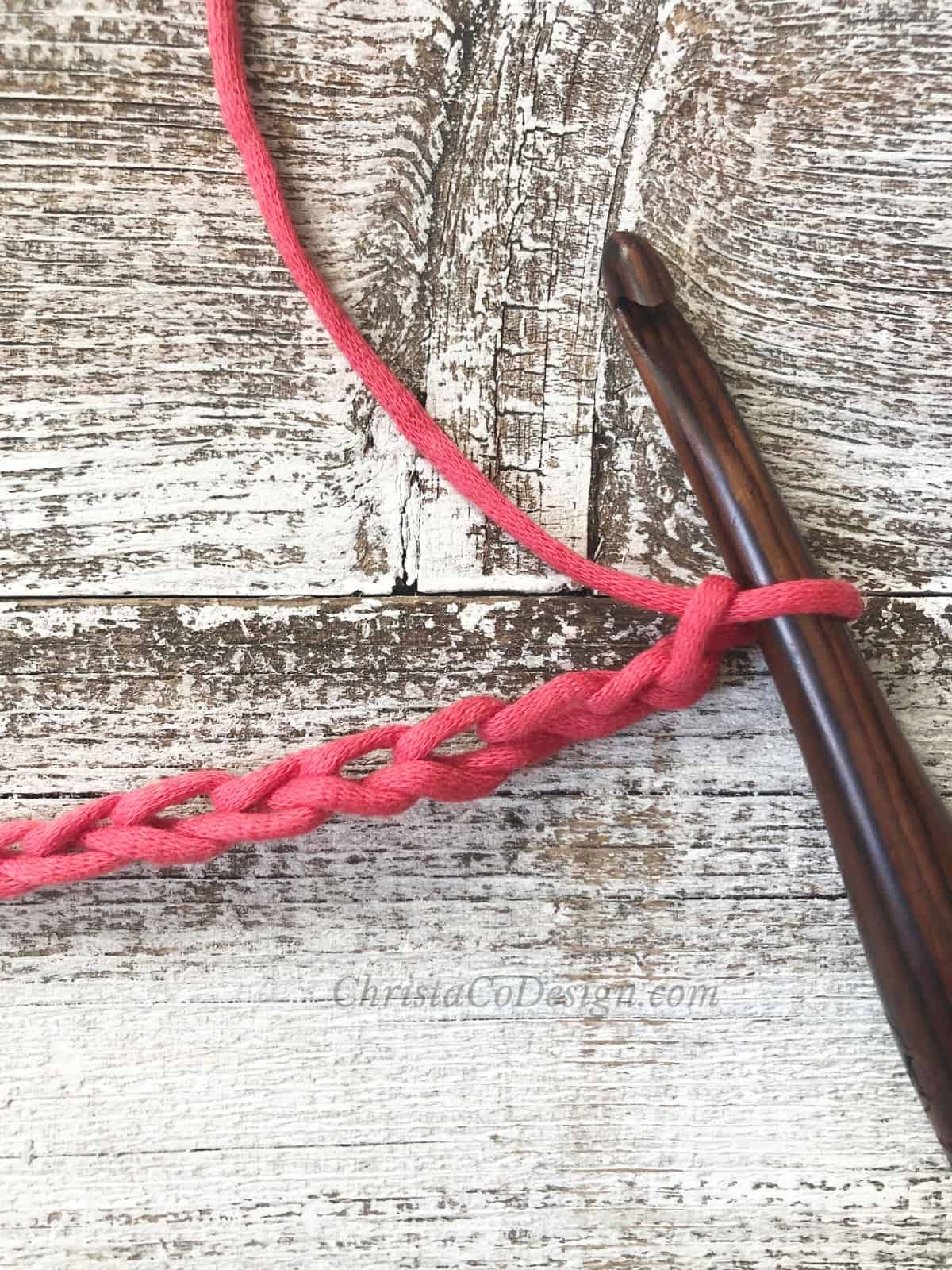 Red chain on wood hook.