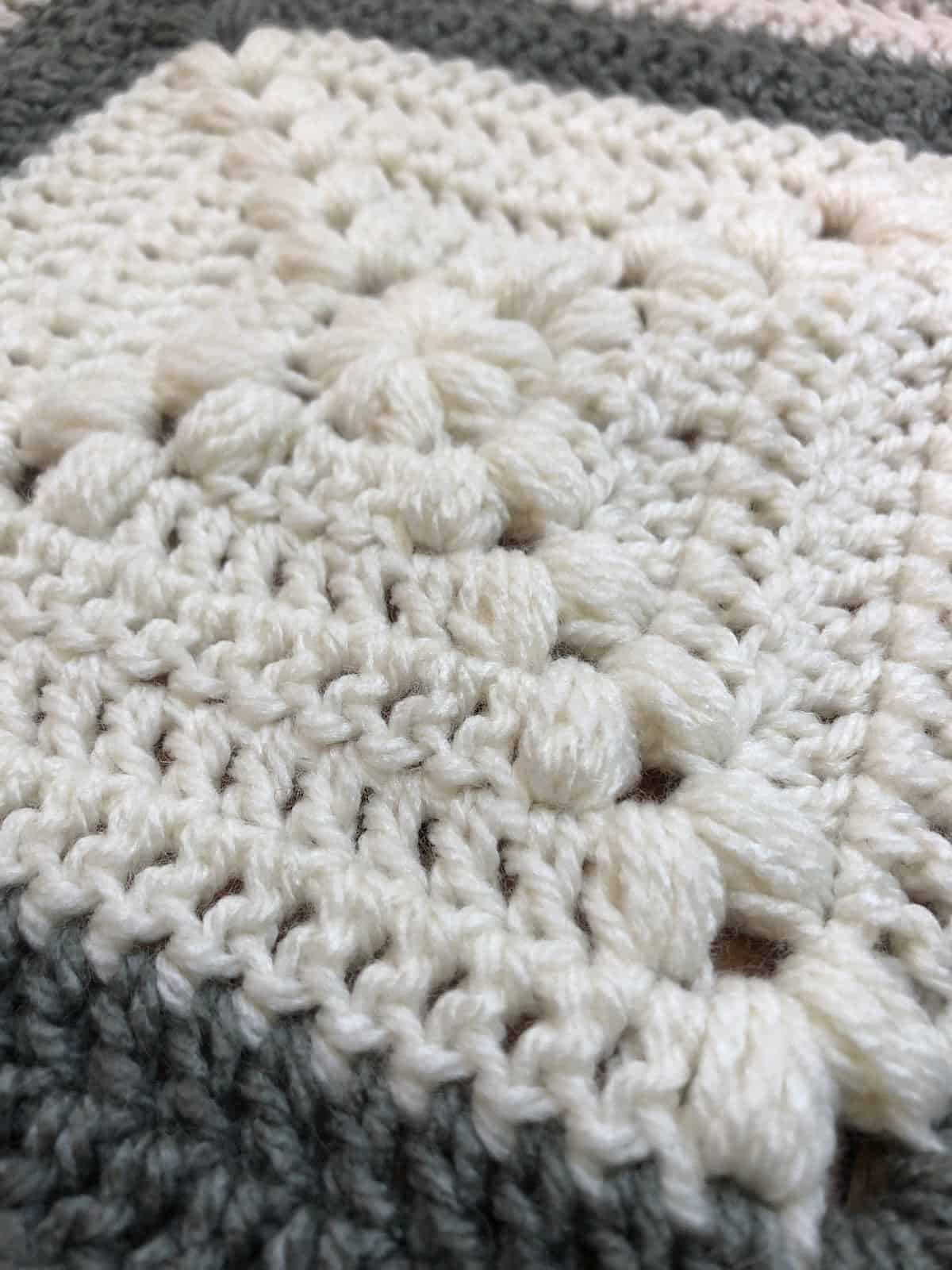 Close up of center of square granny puff stitch blanket.