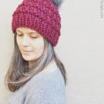 picture of woman in maroon knit hat with Pom Pom