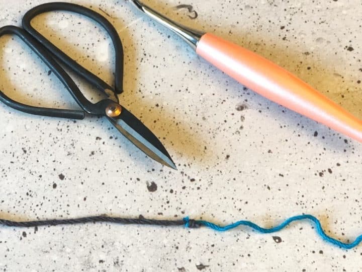 Two yarns joined with the magic knot, scissors, crochet hook.
