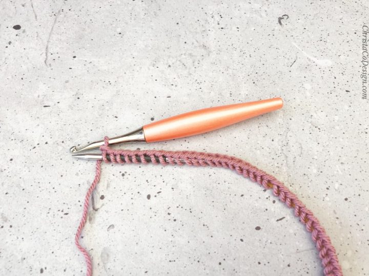 Pink stitches cast on with crochet hook.