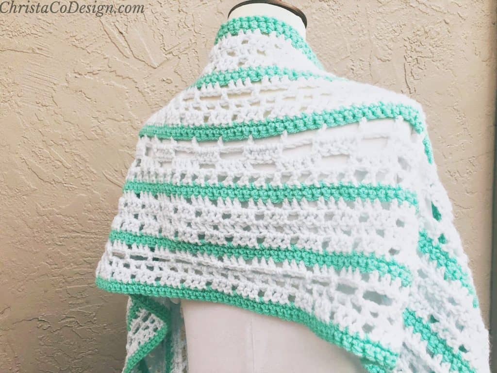 Green and blue shawl striped on mannequin.