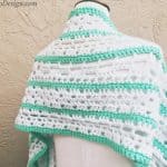 Green and blue shawl striped on mannequin.