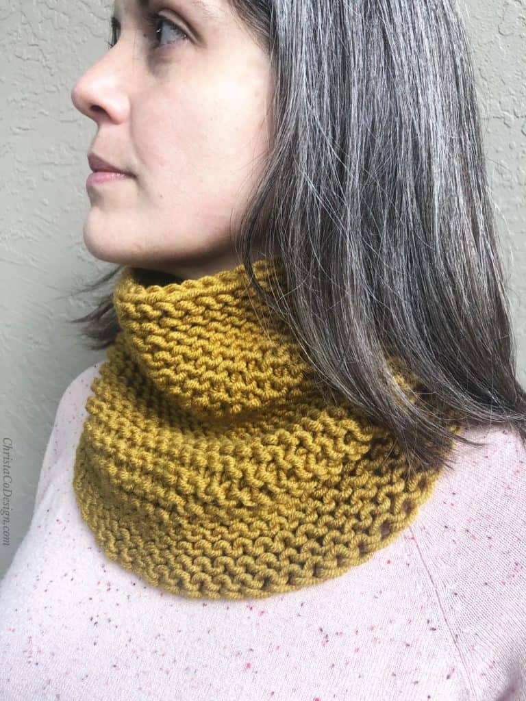 Woman with honey yellow cowl knit in garter on neck.