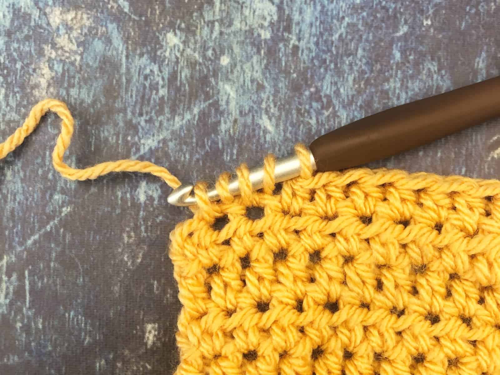 5 loops on hook for half double crochet two together.