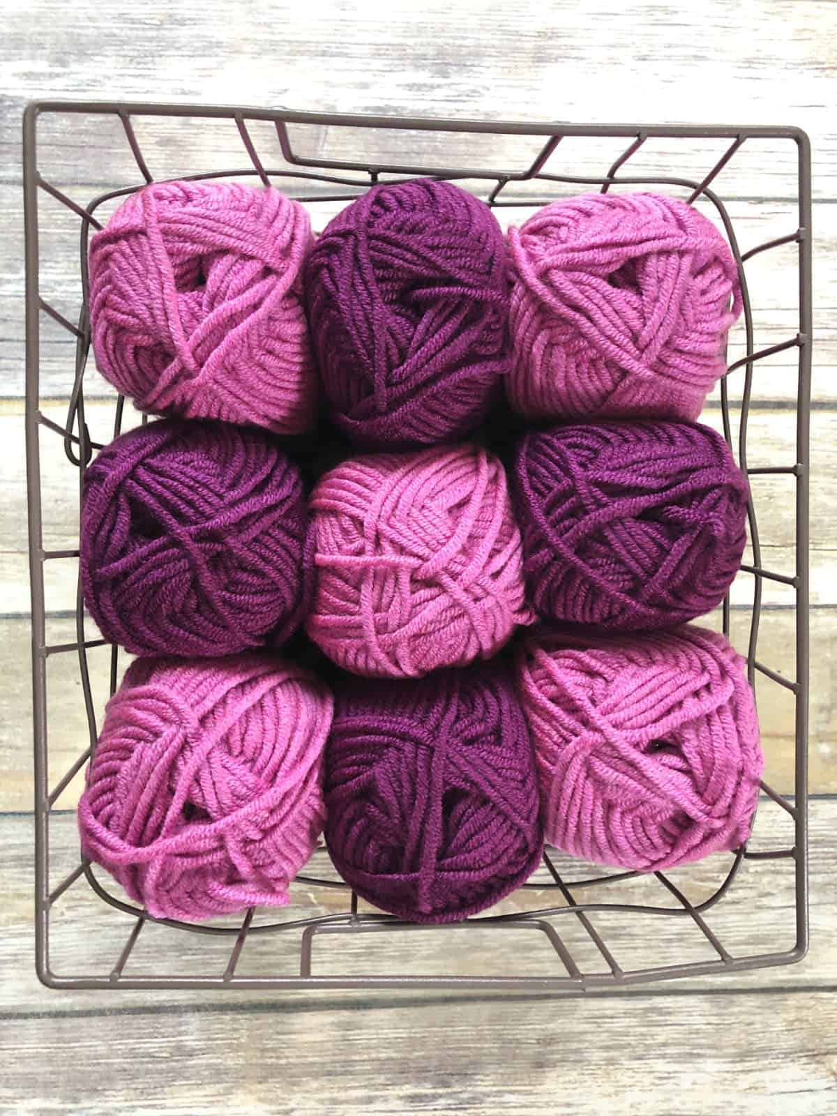 Pink and purple yarn in basket.