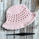 Pink crochet sun hat flat.