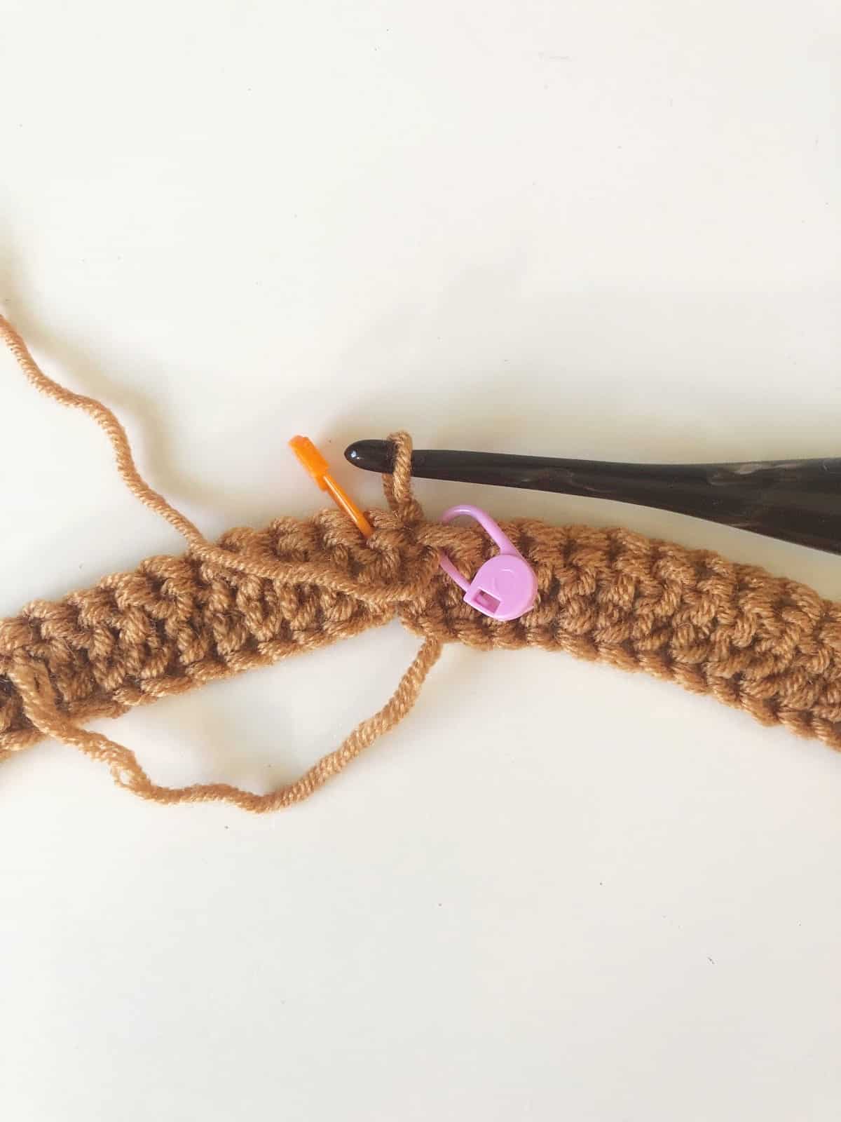Crochet round joined and turned, stitch markers to indicate the first and last stitches.