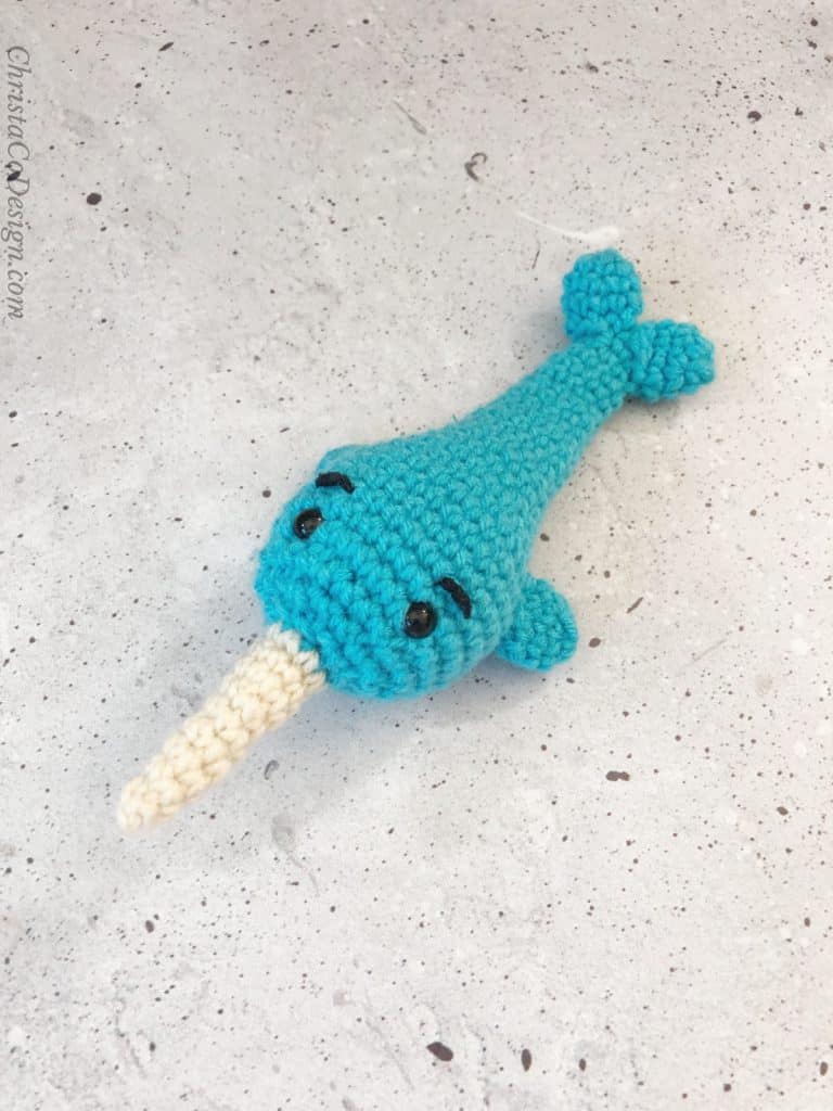 Crochet narwhal with eyebrows.